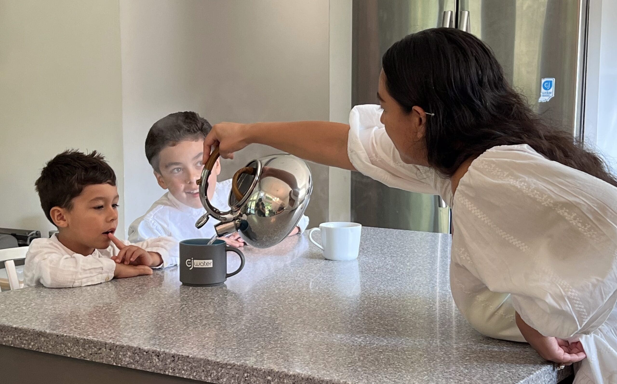 Person pouring into C&J mug.