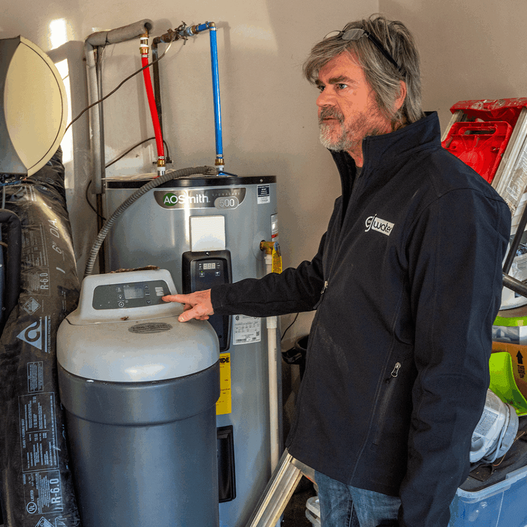 Man pointing at water heater.