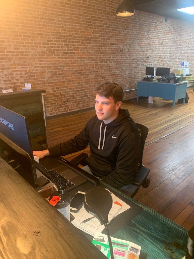 Man working at a computer in an office.