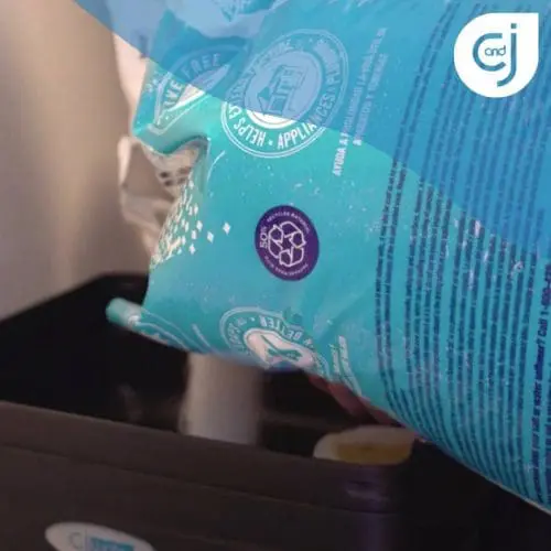 Teal bag with C&J logo over a bin.