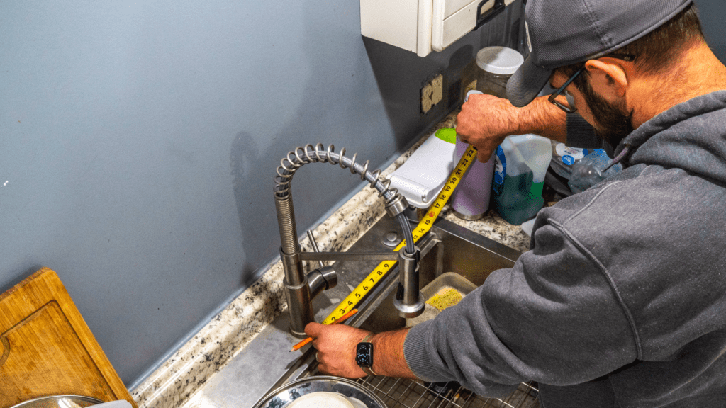 Tankless reverse osmosis water filtration system installed under a kitchen sink for purified drinking water